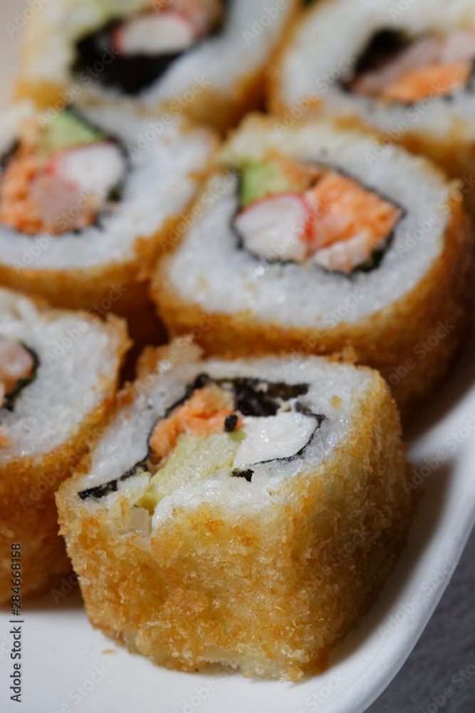 Sushi is traditionally made with medium-grain white rice. It is very often prepared with seafood, such as squid, eel, yellowtail, salmon, tuna or imitation crab meat.