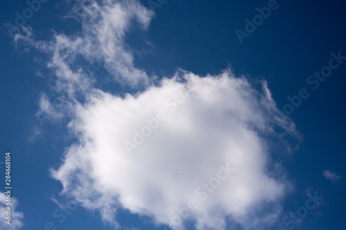 White clouds in the blue sky. Ozone Layer. Blue background