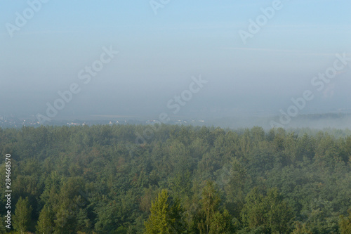 Fog over small town and forest hills in Silesia  Poland  Europe