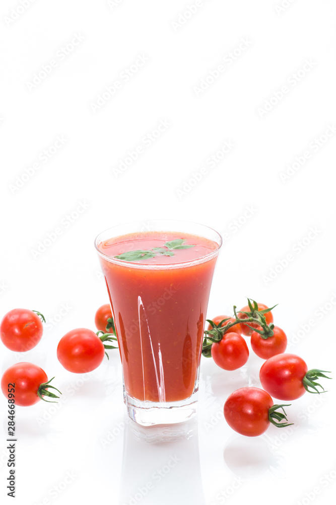 homemade tomato juice in a glass and fresh tomatoes