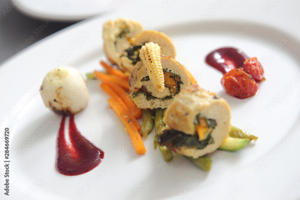 Roasted and sliced chicken fillet stuffed with carrots and pumpkins garnished with vegetables and jamaica sauce. Roasted and sliced chicken fillet stuffed with carrots and pumpkins garnished with vegetables and jamaica sauce.