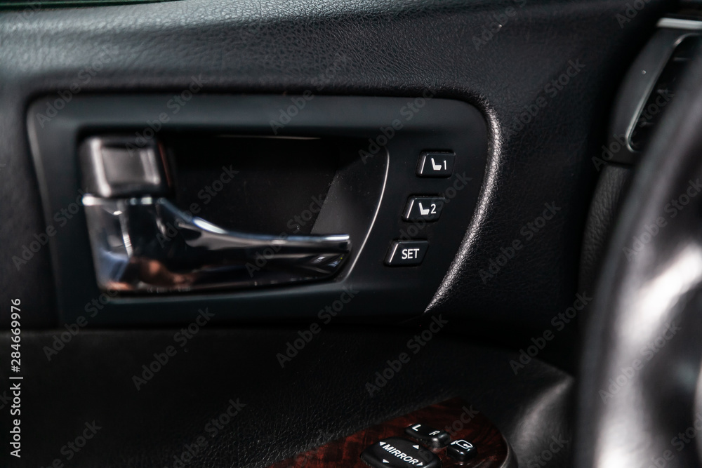 Close-up on the seat adjustment   switch control buttons,  automatic adjust level dashboard. modern car interior: parts, buttons, knobs.
