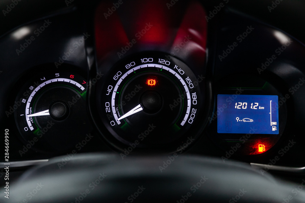 Car dashboard with white  backlight: Odometer, speedometer, tachometer, fuel level, water temperature and more.