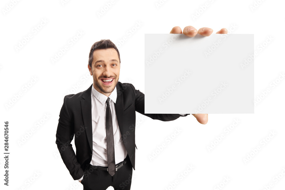 Cheerful young businessman holding a blank card Cheerful young businessman holding a blank card