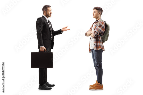 Businessman with a briefcase talking to a male student