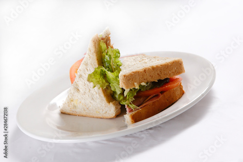 A sandwich club, also called a clubhouse sandwich, is a sandwich of bread, sliced ​​cooked poultry, or fried bacon, lettuce, tomato, and mayonnaise.