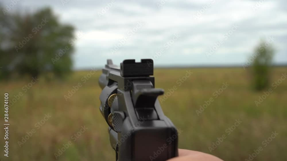 Air gun shoots. First-person view. The weapon in the hands is firing.
