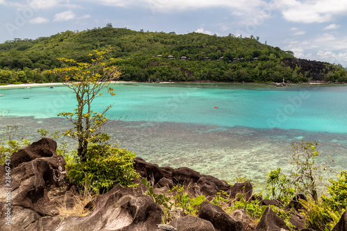 Panoramic view at the landscape on Seychelles island Mahé with turguoise water, mountains and granite rocks