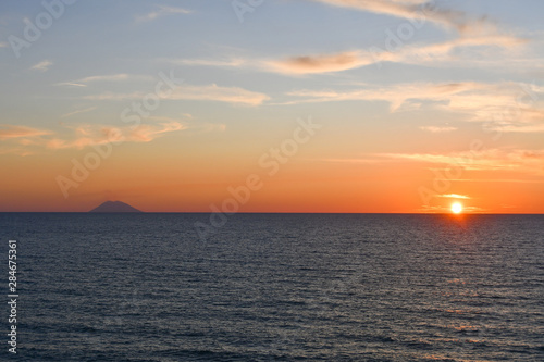 Spectacular sunset over the sea next to the Stromboli volcano