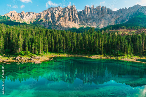 Beautiful turquoise Alpine lake Carezza or Lago di Carezza in Dolomites mountains, South Tyrol, Italy © samael334