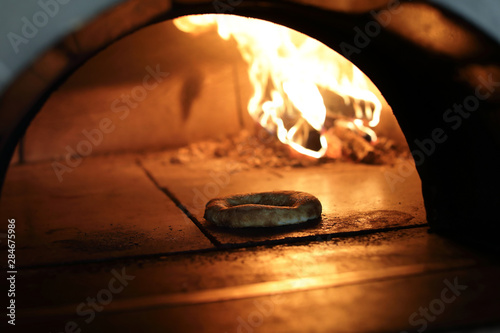 Baking bread in wood oven © Arkady Chubykin