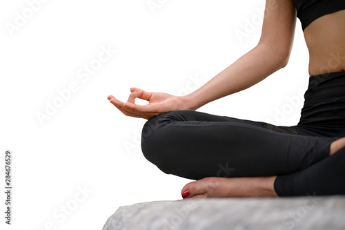 Close-up Young female relaxes in yoga pose on isolated background