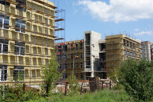 Solid wall insulation with rock wool. Energy efficiency house wall renovation for energy saving. Exterior house wall heat insulation with mineral wool. External wall insulation.