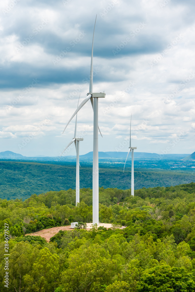 Wind energy turbines in the midst of nature, gorge and trees sky background, Energy generator nature friendly. Spring field. Wind energy turbines in the midst of nature, gorge and trees sky background, Energy generator nature friendly. Spring field.