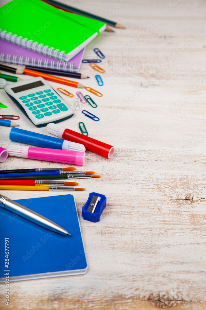 Items for the school on a wooden table.