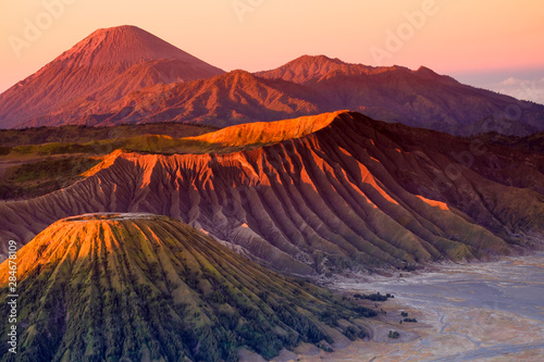 The beautiful sunrise at Mount Bromo volcano, the magnificent view of Mt. Bromo located in Bromo Tengger Semeru National Park, East Java, Indonesia.Image contains noise grain and blurry. photo