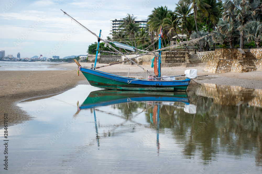Small fishing boats parked on the beach.