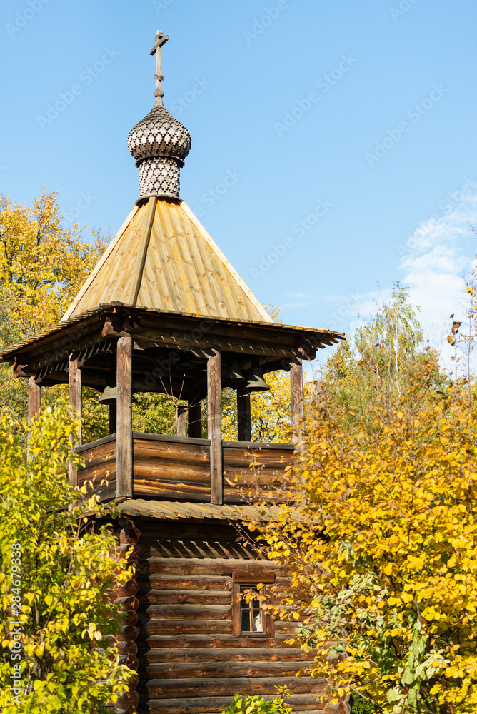 Chapel near the Butovo burial. Wooden Church with bell tower and bells. Orthodox chapel in autumn. Chapel near the Butovo burial. Wooden Church with bell tower and bells. Orthodox chapel in autumn.