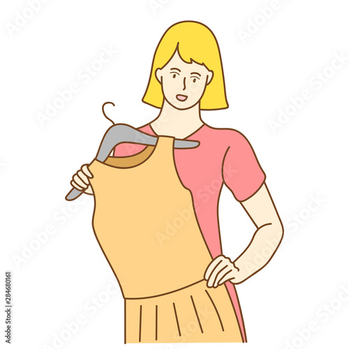 Young woman choosing clothes, the woman trying on new clothes