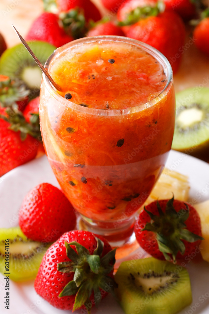 Strawberry juice with lemon served in glass with strawberries and kiwi. Strawberry juice with lemon served in glass with strawberries and kiwi.