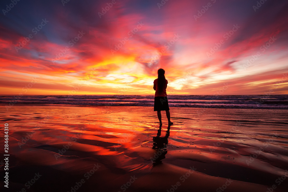 Woman Walking Alone On Beach