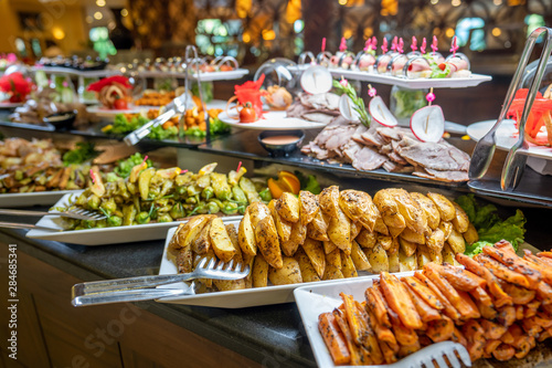 Close up of foods with plates in buffet of restaurant.