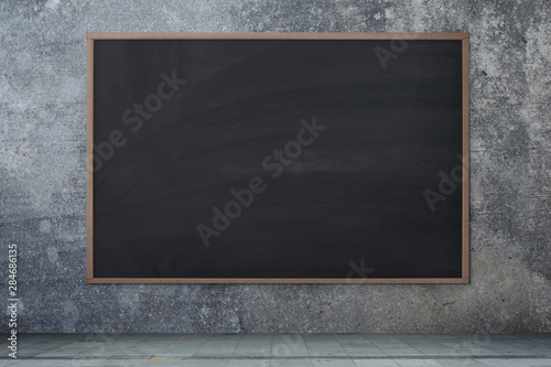 Blackboard texture. Empty blank black chalkboard with chalk traces Concrete wall, cement background.