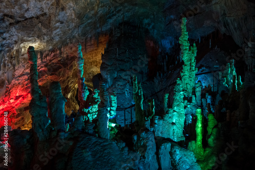 Colorful lighting of stalagmites in the cave of Prometheus, Georgia