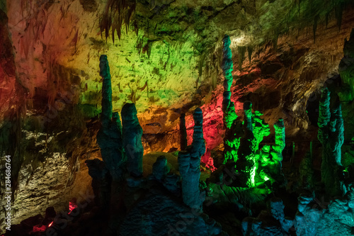 Colorful lighting of stalagmites in the cave of Prometheus, Georgia