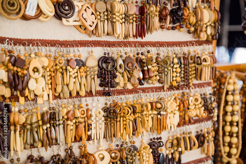 Close up view of wooden earrings at souvenir market