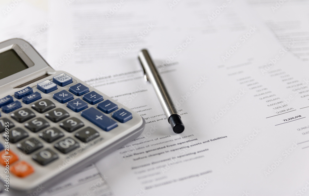 Calculator and pen Placed on accounting Calculator and pen Placed on accounting