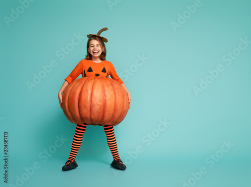 little girl in pumpkin costume photo