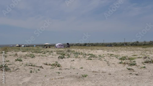 Panorama of the sandy beach in the Crimea. Sand, sea, sky. Wide beach. beach umbrellas. Sun protection. a great place to relax