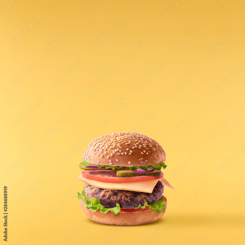 Delicious burger isolated on yellow Delicious burger isolated on yellow