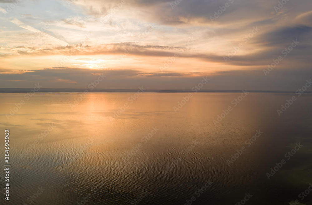 Beautiful view of the sea and sunset. Aerial view from flying drone of a beautiful nature landscape with dramatic clouds sunset sky and views of the sea surface. Postcard view. Nature