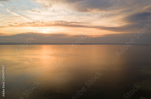 Beautiful view of the sea and sunset. Aerial view from flying drone of a beautiful nature landscape with dramatic clouds sunset sky and views of the sea surface. Postcard view. Nature © svetlichniy_igor