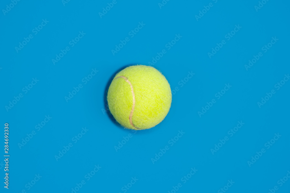 Big tennis ball on blue background
