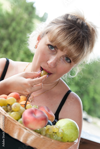 portrait of a beautiful girl with a plate of fruit