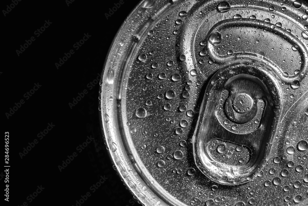 Aluminum can of beverage covered with water drops on black background, top view. Space for text Aluminum can of beverage covered with water drops on black background, top view. Space for text
