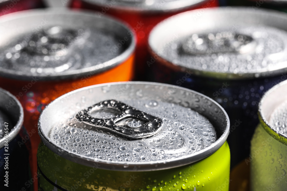 Aluminum cans of beverage covered with water drops as background, closeup Aluminum cans of beverage covered with water drops as background, closeup
