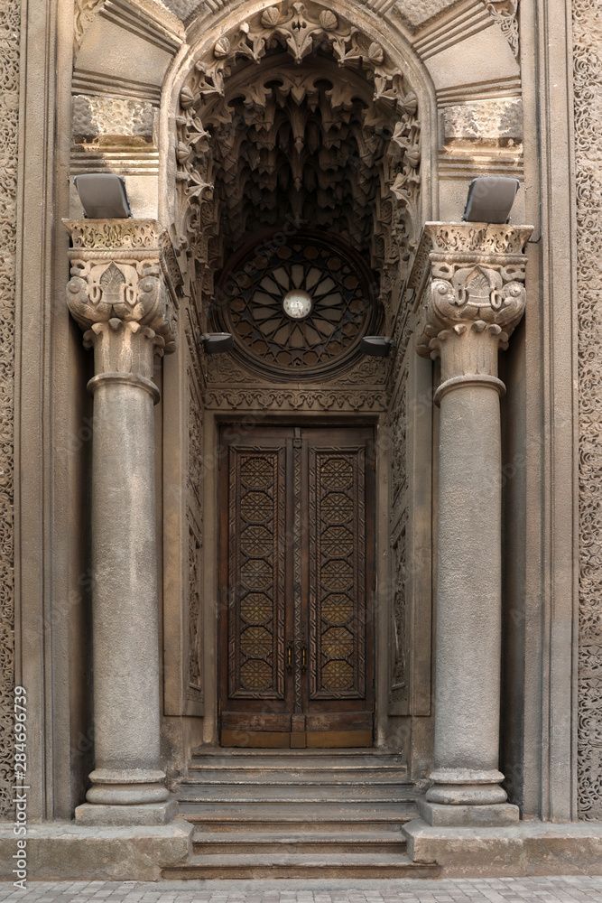 Beautiful old building with arch and ornate door