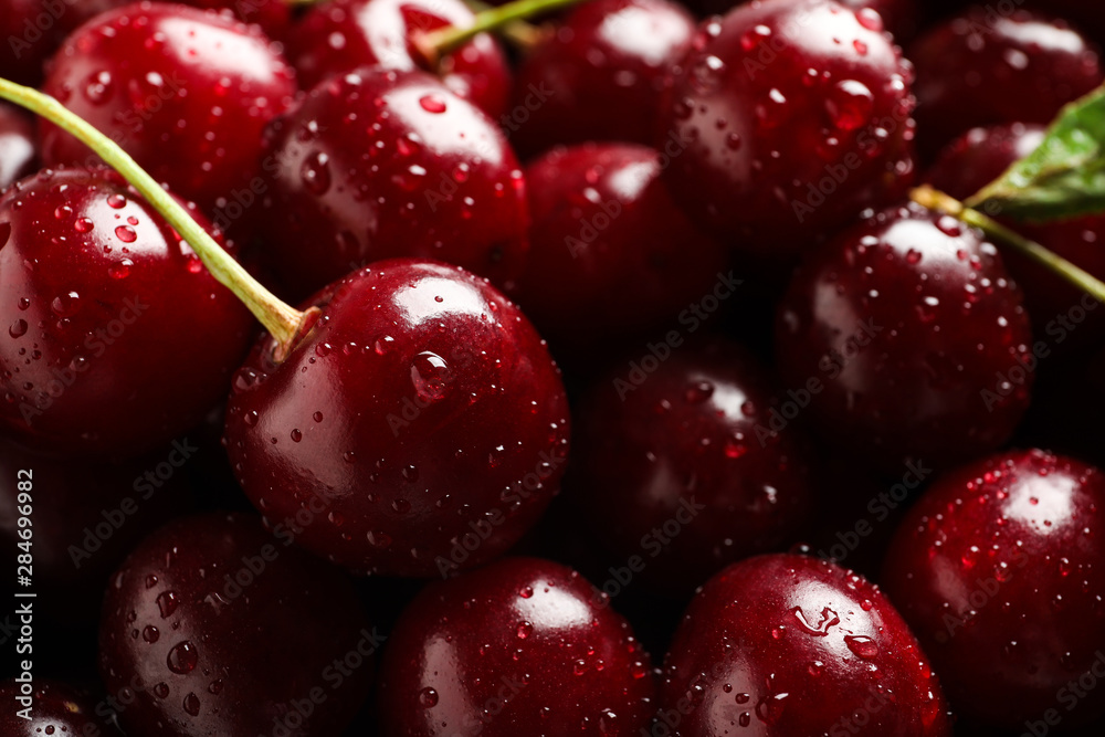 Delicious ripe sweet cherries with water drops as background, closeup view Delicious ripe sweet cherries with water drops as background, closeup view