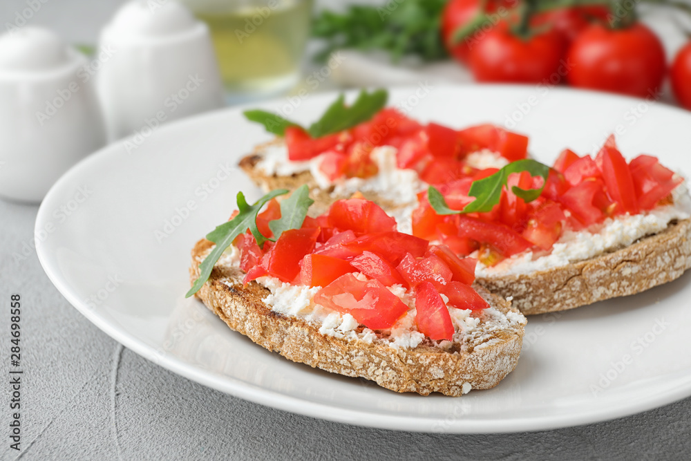 Plate of delicious tomato bruschettas on table, closeup Plate of delicious tomato bruschettas on table, closeup