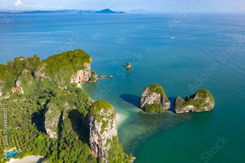Fototapeta Naklejka Na Ścianę i Meble -  Aerial view of tropical island, turquoise lagoon and islands on horizon, Krabi, Railay, Thailand.Travelling and holiday concept.