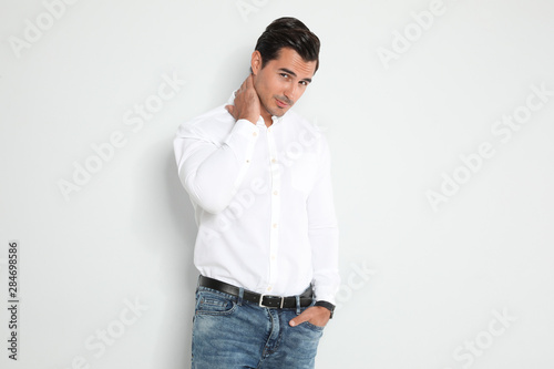 Portrait of handsome young man on light background © New Africa