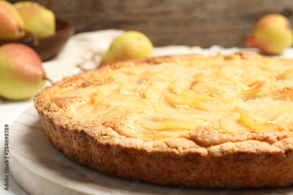 Delicious sweet pear tart on table, closeup Delicious sweet pear tart on table, closeup