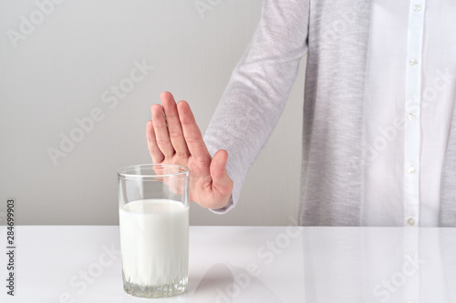 Obraz na plátně woman with lactose intolerance refusing glass of milk