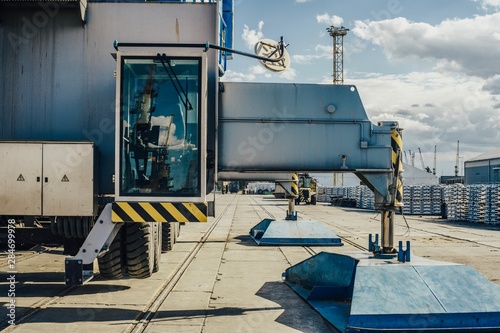 Cargo at the port. Aluminum ingots on the pier. Against the background of cargo depots and ships