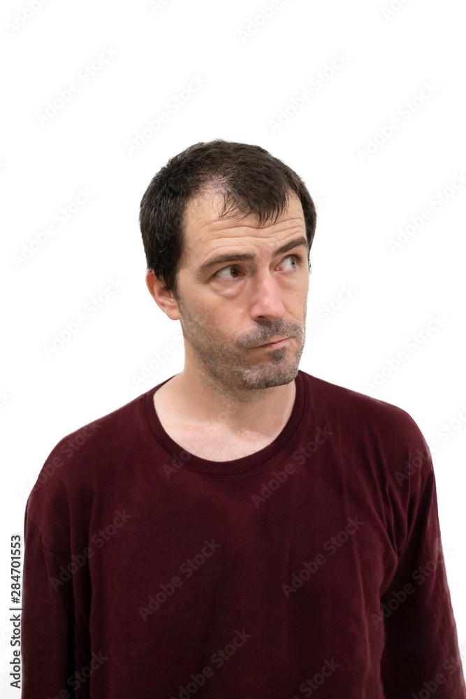 Portrait of a man looking to the side with curious Portrait of a man looking to the side with curious