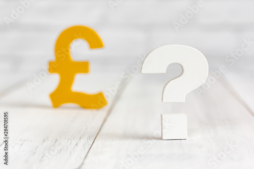 Question mark with pound sign on white wood table over white brick background with copy space. photo